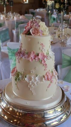 a wedding cake with pink and white flowers on it