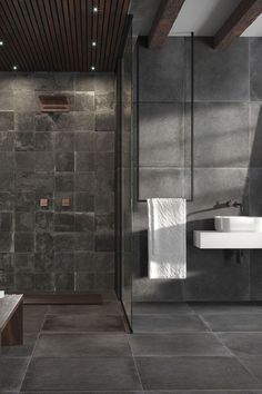 a modern bathroom with stone walls and flooring