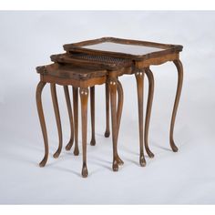 three wooden nesting tables with glass tops