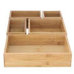 three wooden drawers sitting on top of each other in front of a white background with the bottom drawer open