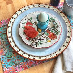 a table setting with plates, cups and utensils