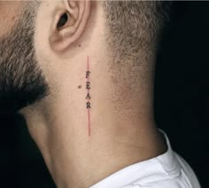 a man's neck with the word fear written on his left side ribcage