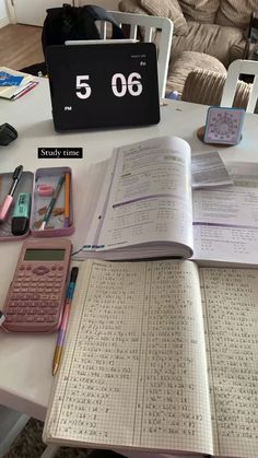 an open book sitting on top of a table next to a calculator