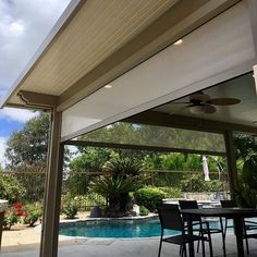 an outdoor dining area next to a pool