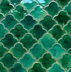 a close up view of a green tile pattern