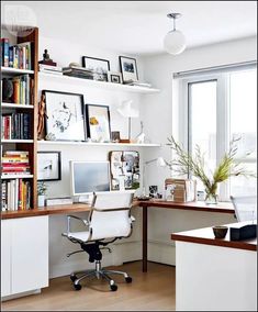 a home office with bookshelves, desk and computer on top of the desk