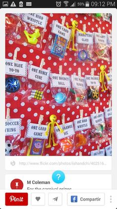 there are many toys on the table for sale in this shopfront window, including plastic figures and cards