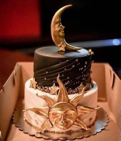 a three tiered cake decorated with a crescent and the moon