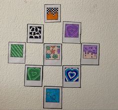 a white wall with pictures on it and hearts drawn on the squares in different colors