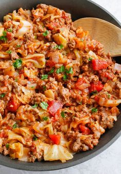 a skillet filled with pasta and meat