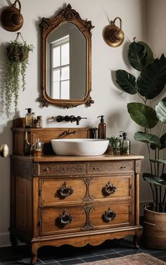 a bathroom with a sink, mirror and potted plants