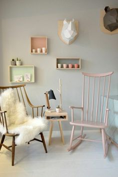 two rocking chairs and a desk in a room