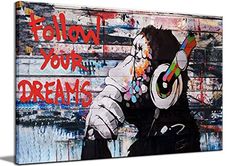 a painting on the side of a building that says follow your dreams with headphones