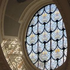 a circular stained glass window in the center of a building