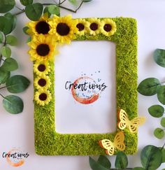 a photo frame with sunflowers and grass