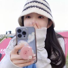 a girl holding her phone up to her face