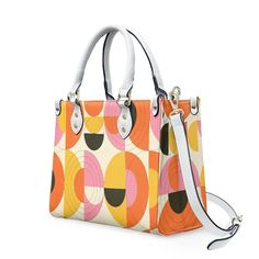 • Elevate your style with our retro style 60s Space Age Opt Art Handbag, a chic fusion of mod and vintage aesthetics inspired by the iconic designs of the 60s.• This Mod 60s Handbag features a mesmerizing geometric opt art pattern print in vibrant shades of orange, pink, yellow, and black, adding a bold and artistic touch to any outfit.• Crafted from premium PU leather, this Retro Handbag Women boasts an exquisite zipper closure and comes with a removable strap for added versatility.• Available in three sizes - small, medium, and large - and with two handle options in black and white, this 60s Style Handbag offers both style and practicality for every occasion.**Designed in California by Trendy Hip Buys. Made to order from overseas.