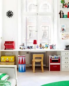 a child's playroom with toys and art on the wall