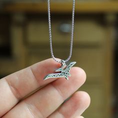 Pewter Dinosaur NecklaceThis sweet Pterodactyl or Pteranodon is made from hand cast pewter. The pendant is covered with geometric patterns and is bound to spark conversation about just what these dragon like creatures really looked like. This is an awesome Dinosaur Necklace!This hand cast modern pewter necklace measures a little over 1/2 an inch tall and a little over 3/4 of an inch wide. It hangs from a 1.4mm stainless steel rounded box chain that is adjustable between 16 and 20 inches. Each it Dinosaur Pendant, Dinosaur Necklace, Round Box, Hand Cast, Box Chain, Geometric Patterns, Spring Rings, Charm Necklace, Silver Plate