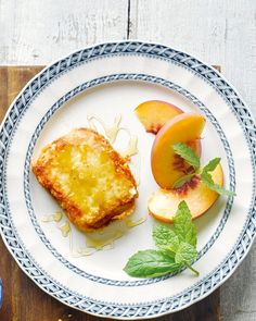 a white plate topped with food next to sliced peaches