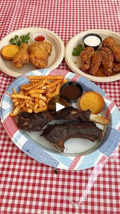 a table topped with plates of food and meat on top of a checkered table cloth