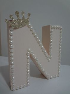 the letter n is decorated with pearls and a crown