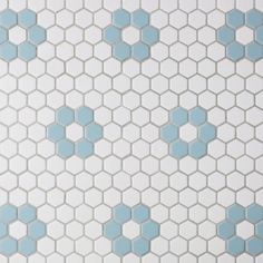 a white and blue tiled wall with hexagonal tiles