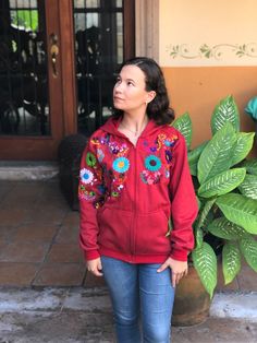 This beautiful sweatshirt is hand embroidered by Mexican artisans. It's great for keeping you warm in cold weather. It has a beautiful multi-colored floral embroidery. Sweatshirt has a kangaroo pouch on the front. We ship anywhere in the word, from Tepic, Nayarit, mx. Made by artisans from Oaxaca, mx Embroidered Hooded Sweatshirt For Winter, Hooded Embroidered Sweatshirt For Winter, Embroidered Fall Hoodie Outerwear, Embroidered Red Hoodie For Fall, Red Embroidered Hoodie For Fall, Embroidered Cotton Hooded Outerwear, Hooded Cotton Embroidered Outerwear, Hooded Cotton Outerwear With Embroidery, Red Embroidered Cotton Hoodie