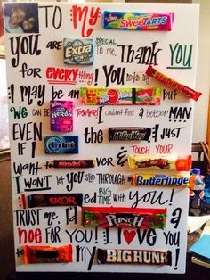 a refrigerator decorated with candy bar magnets and writing on the fridge's side