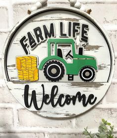 a sign that says farm life welcome with a tractor and hay bales on it