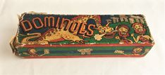 an old fashioned dominos box with lions and lions on the front, sitting on a white surface