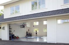 two men are playing basketball in the garage