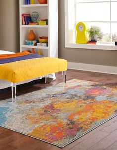 a brightly colored rug in the middle of a room