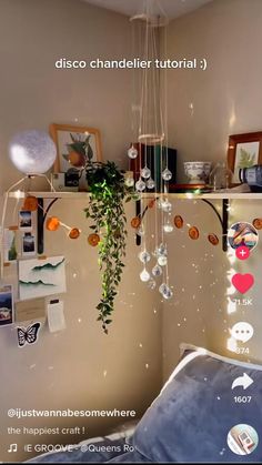 a bed room with a hanging plant and pictures on the wall