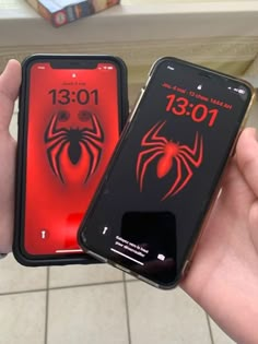 two cell phones with spiderman cases on them