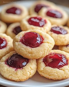 cookies with jelly filling on a white plate