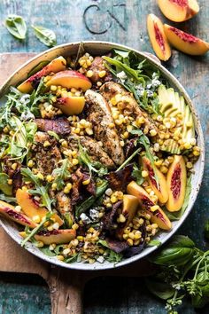 a salad with peaches, corn and other vegetables