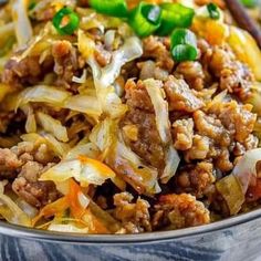 a bowl filled with meat and vegetables on top of a table