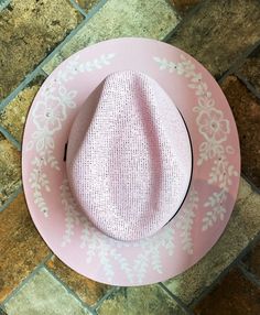 Turn heads with this beautiful one-of-kind baby pink fedora. This cute and feminine design will add a soft yet unique touch to anyone who wears her! The unique design is handpainted by me. There are Swarovski crystal permanently adhered and almost impossible to remove, I've tried! The paint is sealed so cleaning it will not remove the paint!  My mission is to bring the joy of living in the moment by creating beautiful pieces that bring a relaxed and festive vibe to every day! This hat is handmade in Mexico and hand painted by me Enjoy this water resistant fashion statement by the pool, or grilling outside. This jute hat is breathable, and fits comfortably as it protects you from the harsh sun. The hat is about 23 inches in circumference & right now sizers are included at no additional cost Cheap Pink Hat Bands For Rodeo, Cheap Pink Acrylic Hats, Pink Western Straw Hat For Summer, Pink Adjustable Hat Bands For Summer, Pink Straw Hat With Curved Brim For Rodeo, Pink Straw Hat For Rodeo, Summer, Pink Brimmed Hat For Rodeo, Pink Summer Straw Hat For Rodeo, Pink Short Brim Straw Hat For Rodeo