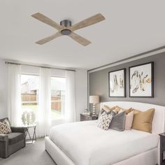 a bedroom with a ceiling fan and white bed