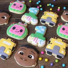 decorated cookies with school buses and cars on a table