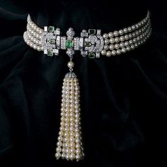 A four-strand pearl necklace with a round and baguette-shaped diamond clasp at the center, accented with seven emeralds weighing a total of approximately 3.04 carats. Suspending is a ten strand tassel of graduated pearls with a diamond-set cap from a single pearl, the pearls weighing a total of approximately 268 carats, and the diamonds weighing a total of approximately 6.79 carats, mounted in 18 K gold Pearl Diamond Choker, Art Deco Choker, Mikimoto Necklace, Diamond And Pearl Necklace, Art Deco Jewelry Box, Art Deco Jewelry Rings, Art Deco Inspired Jewelry, Emerald Choker, Pearl Diamond Necklace