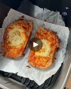 two slices of pizza sitting on top of a pan covered in cheese and tomato sauce