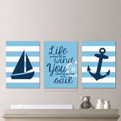 three blue and white wall art pieces with an anchor, sailboat and life quote