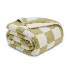 the green and white checkered towel is folded up on top of each other,