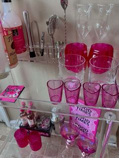 there are many pink glasses on the shelf