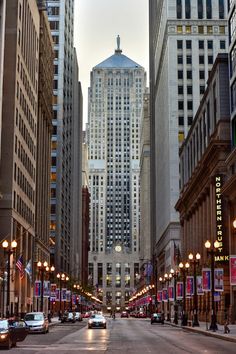 an empty city street with tall buildings in the background