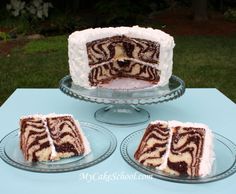 three slices of zebra print cake sitting on plates next to each other in front of a blue table