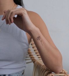 a woman with a small tattoo on her arm