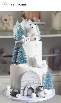 there is a cake decorated with animals and trees on the top tier, along with other decorations